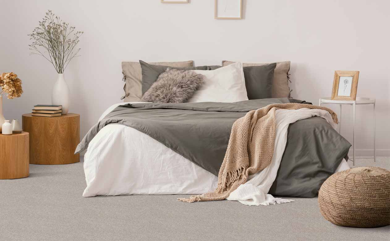 College Point bedroom with bed and grey carpeted floor