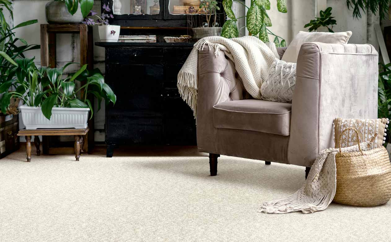 Living room in College Point with brown chair and dresser with beige carpet